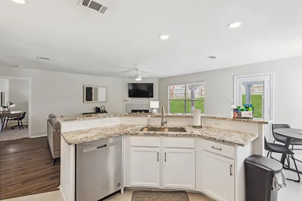 a kitchen with a sink stove and wooden cabinets