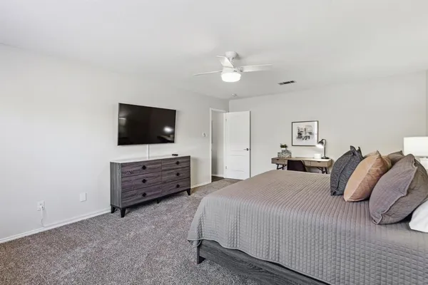 a bedroom with a bed and a flat screen tv