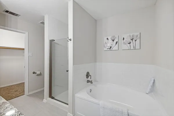 a white bath tub sitting next to a white wall