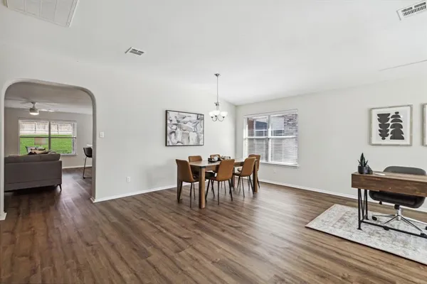 a view of a dining room with furniture window and wooden floor