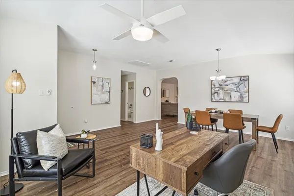 a living room with furniture and wooden floor
