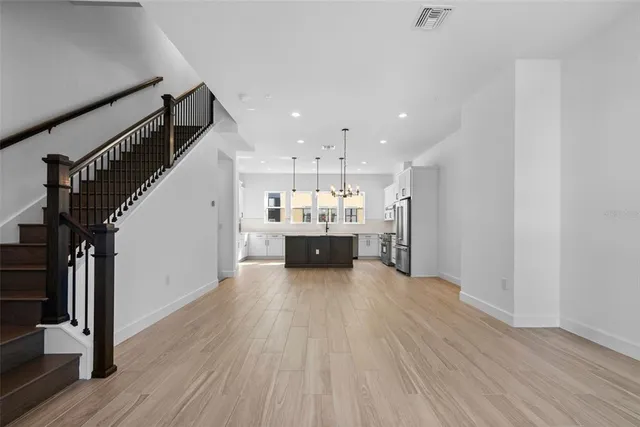a view of a kitchen with wooden floor and a kitchen