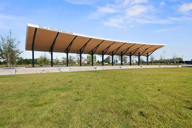 a view of a park with plants and palm trees