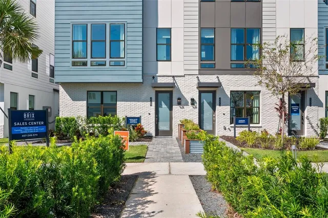 a front view of a house with garden and porch