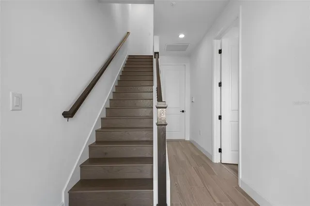 a view of entryway and gallery with wooden floor
