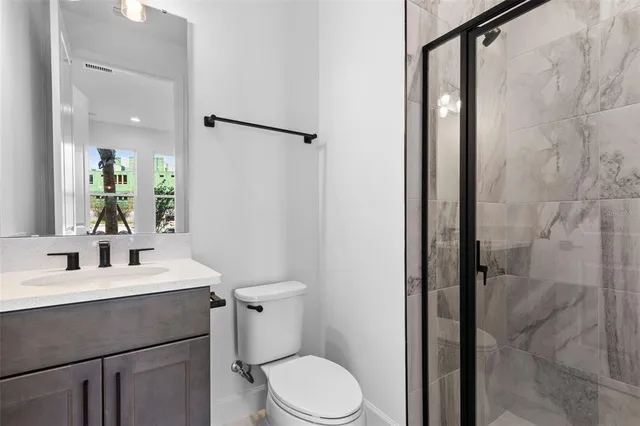 a bathroom with a sink toilet and shower