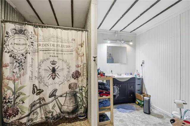 a bathroom with a toilet sink and mirror