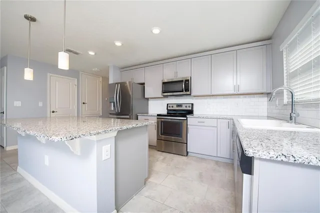 a stove top oven sitting inside of a kitchen