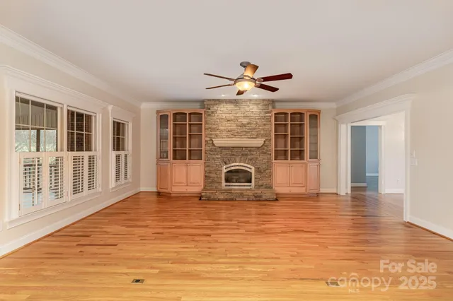 a view of a livingroom with a ceiling fan and window