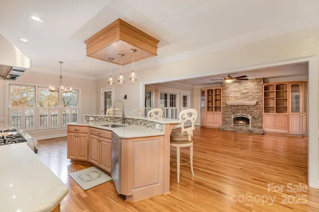 a kitchen with stainless steel appliances granite countertop a stove and cabinets