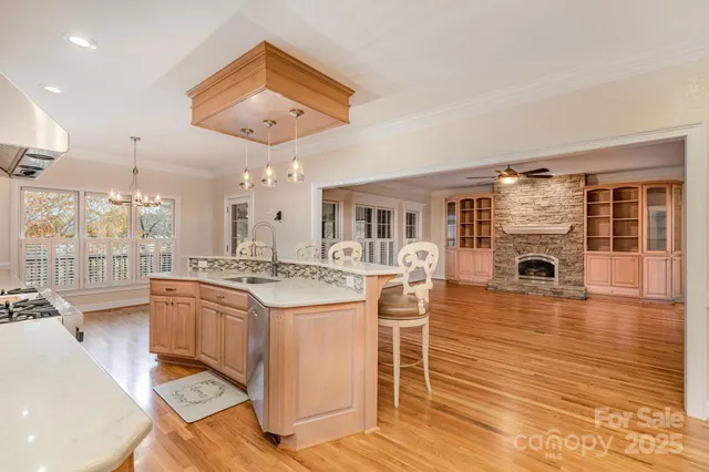 a kitchen with stainless steel appliances granite countertop a stove and cabinets