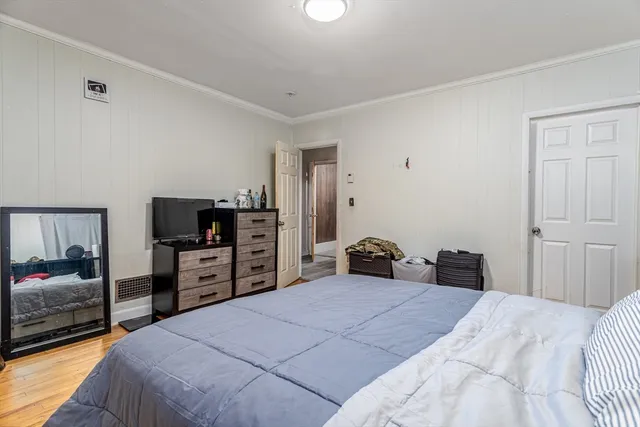 a bedroom with a bed and a television