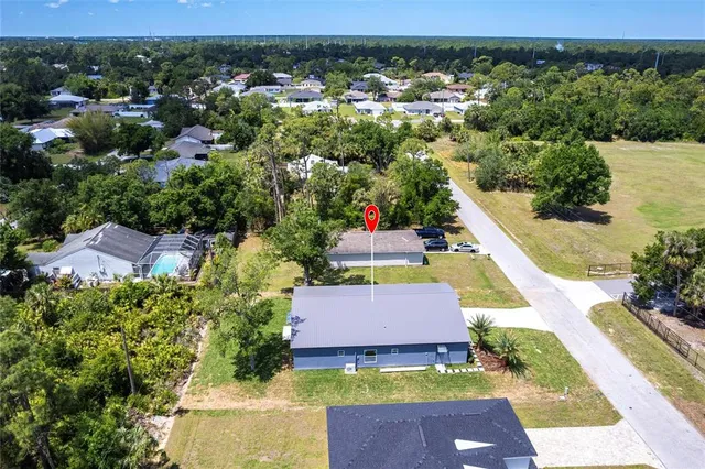 an aerial view of a house and front yard