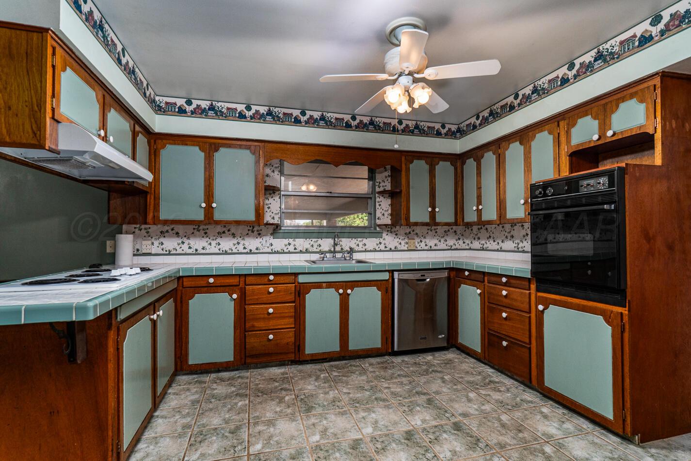 300 Mccarthy Street Borger, TX 79007 - Photo 6 of 31 a kitchen with stainless steel appliances granite countertop a sink stove and cabinets