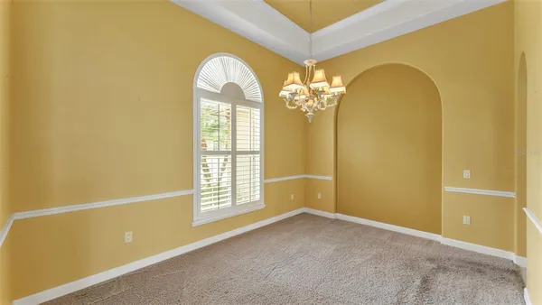 a large bedroom with bed and glass door