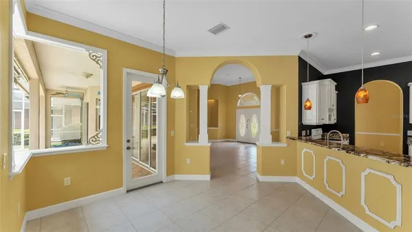 a kitchen with white cabinets sink and stove