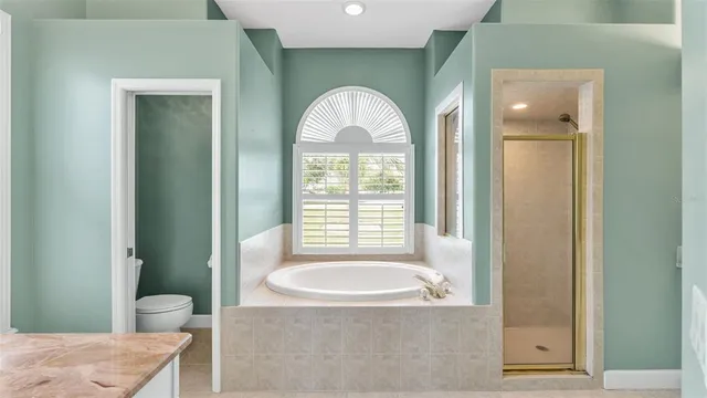 a view of a livingroom with a window and a chandelier