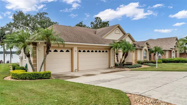 a view of a house with a yard and garage
