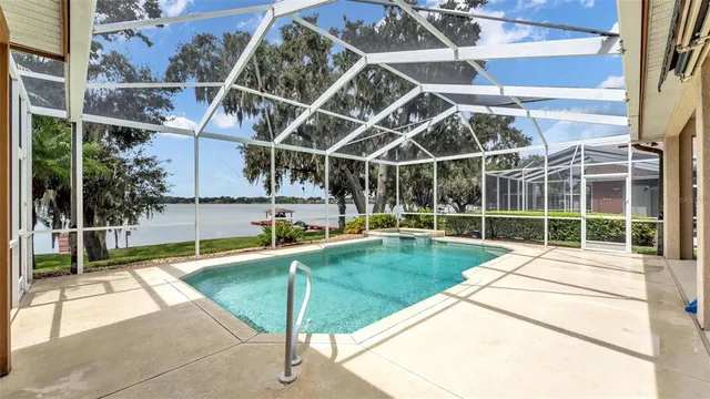 a view of a backyard with a small deck and a garden
