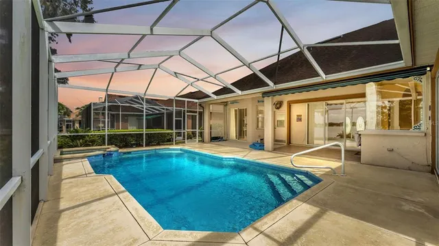 an aerial view of a house with a yard and lake