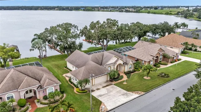 an aerial view of a house with garden space and ocean view