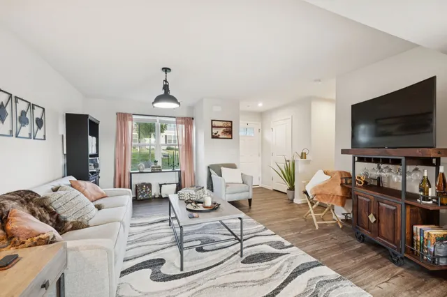 a kitchen with a refrigerator and wooden floor