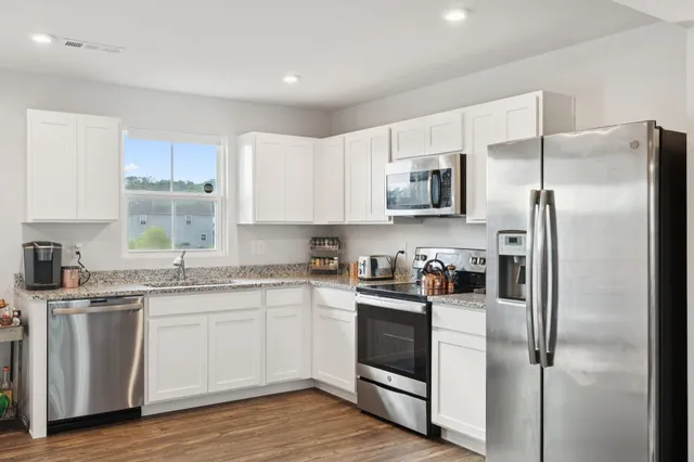 a kitchen with a refrigerator stove and microwave