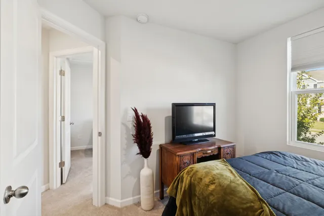 a bedroom with a bed and window