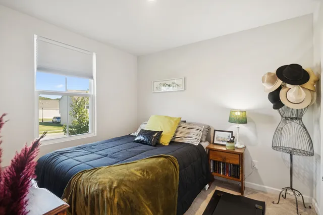 a view of a workspace with furniture and a bookshelf