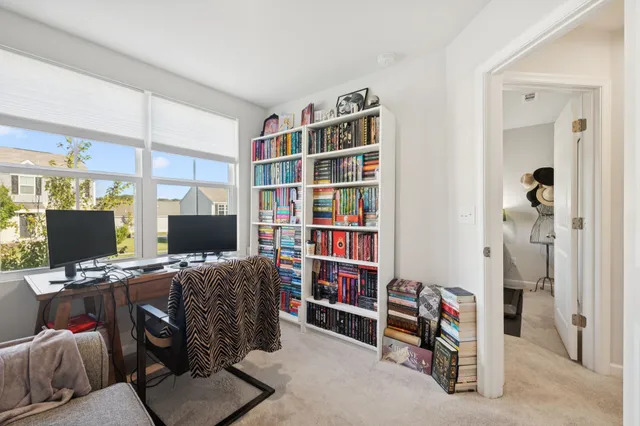 a living room with furniture a flat screen tv and a window