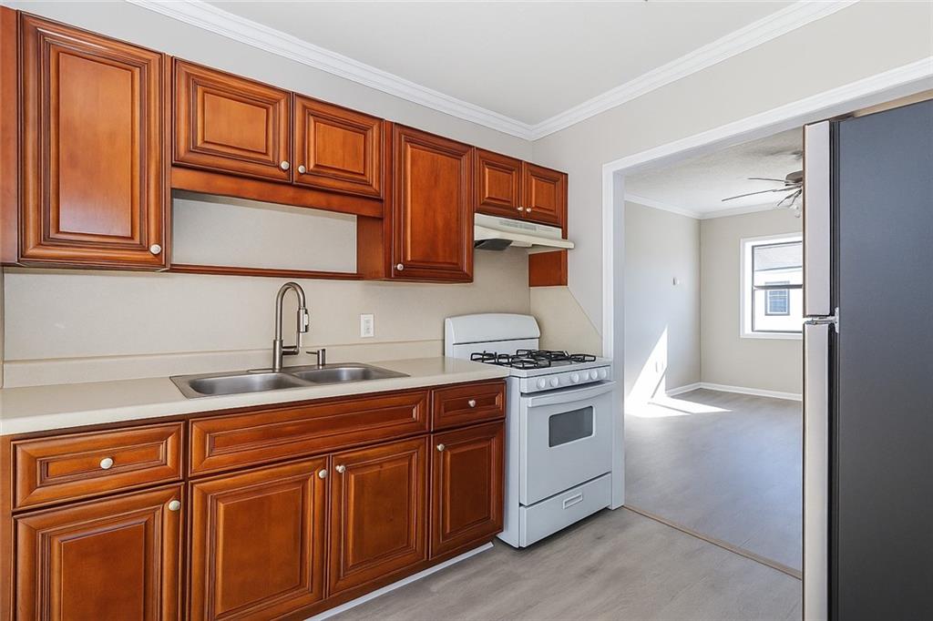 949 Washington Street Southwest, Unit 16 Atlanta, GA 30315 - Photo 12 of 14 a kitchen with stainless steel appliances granite countertop a sink stove and cabinets