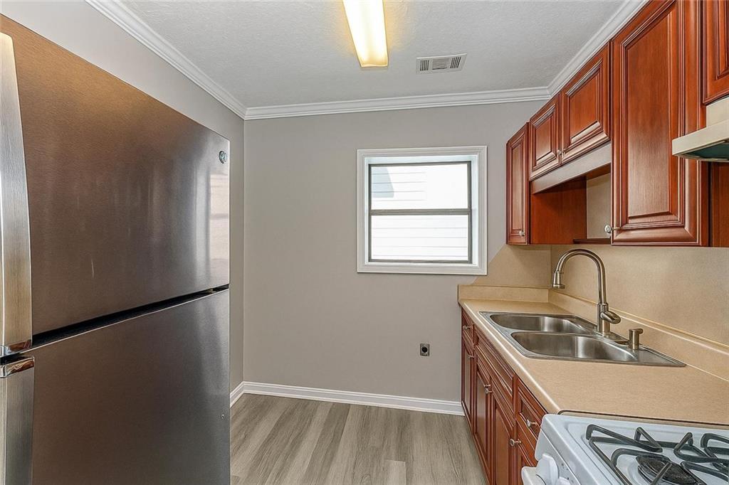 949 Washington Street Southwest, Unit 16 Atlanta, GA 30315 - Photo 13 of 14 a kitchen that has a sink a refrigerator and window