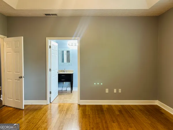 a view of room with wooden floor