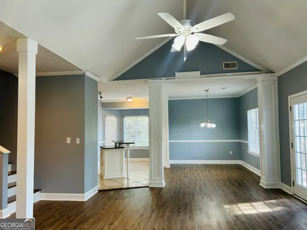 a view of empty room with wooden floor