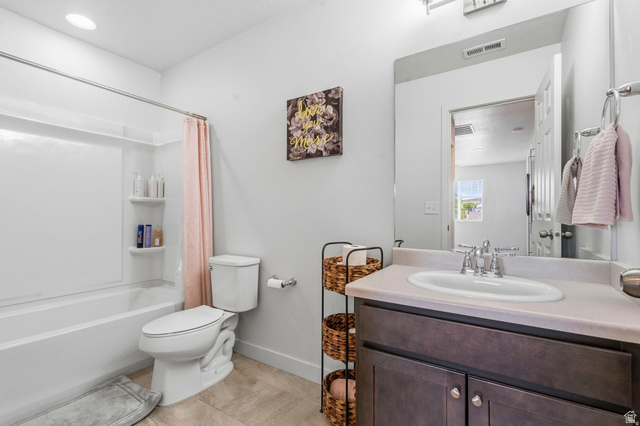 7685 Timber Country Road Eagle Mountain, UT 84005 - Photo 23 of 39 Bathroom featuring a dark wood-finish vanity with a light countertop, an undermount sink with a chrome faucet, and a large wall-mounted mirror
