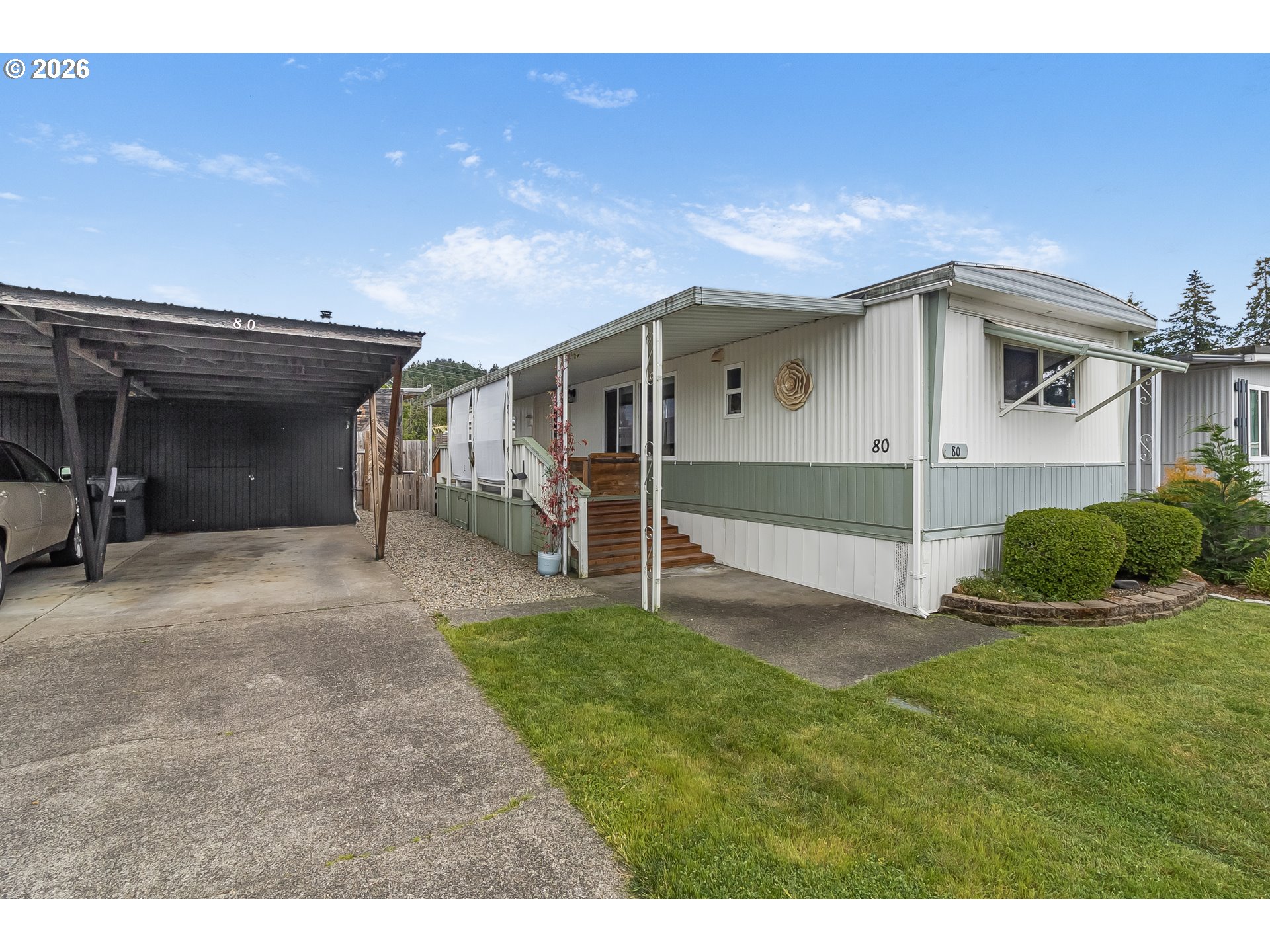205 South 54th Street, Unit 80 Springfield, OR 97478 - Photo 35 of 37 a view of a house with a yard and garage