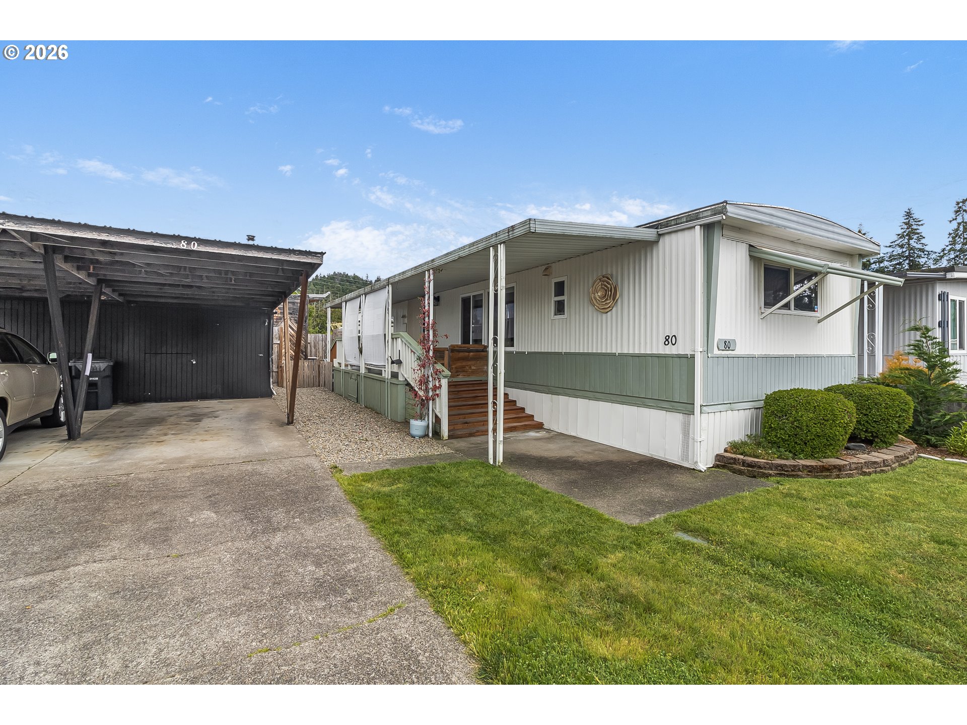 205 South 54th Street, Unit 80 Springfield, OR 97478 - Photo 36 of 37 a view of a house with a yard and a garage