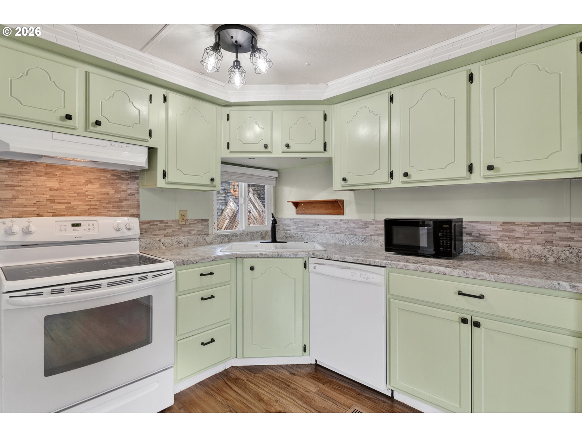 205 South 54th Street, Unit 80 Springfield, OR 97478 - Photo 10 of 37 a kitchen with granite countertop white cabinets and stainless steel appliances