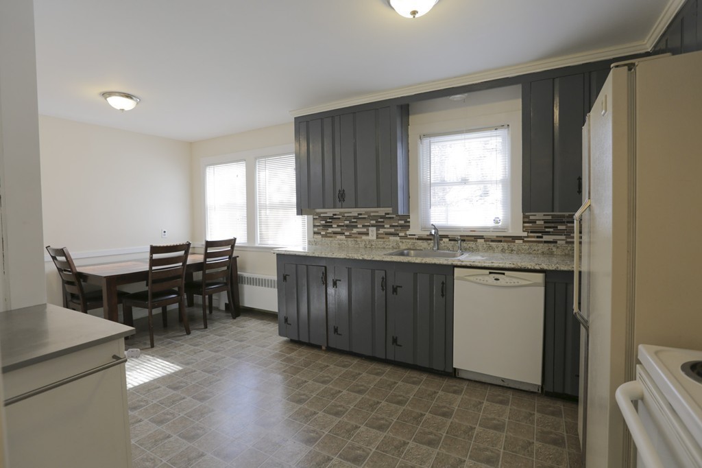 7 Pickman Road Salem, MA 01970 - Photo 18 of 25 a kitchen with granite countertop cabinets a dining table and chairs