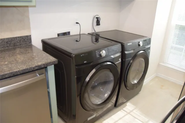 a utility room with sink dryer and washer