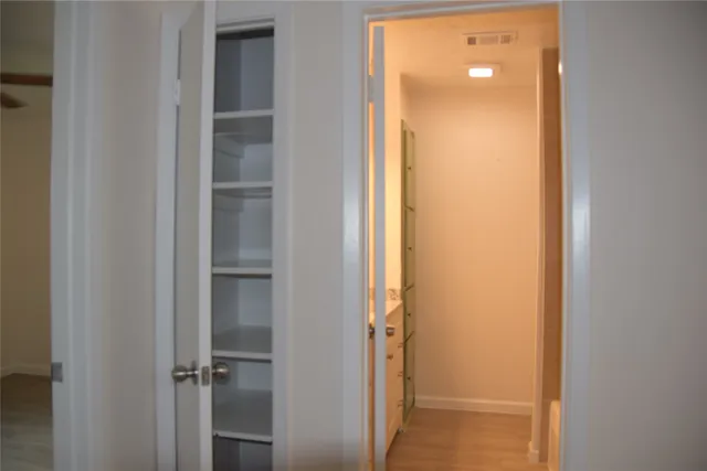 a view of a bathroom from a hallway