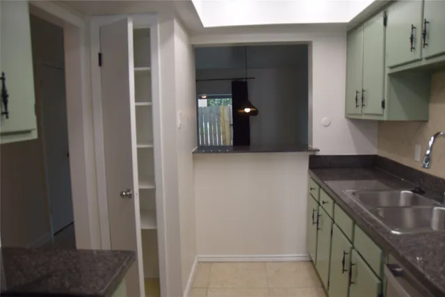 a kitchen with a sink stove and cabinets