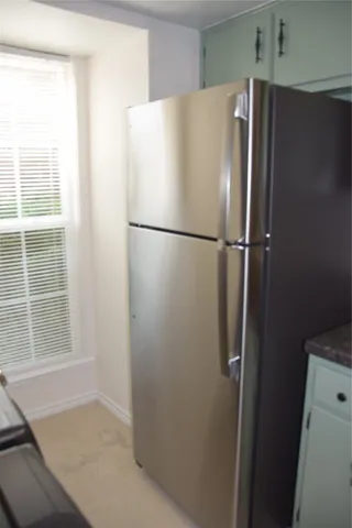 a white refrigerator freezer sitting in a kitchen