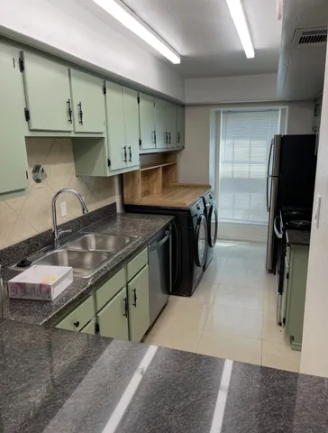 a kitchen with stainless steel appliances granite countertop a sink stove and cabinets