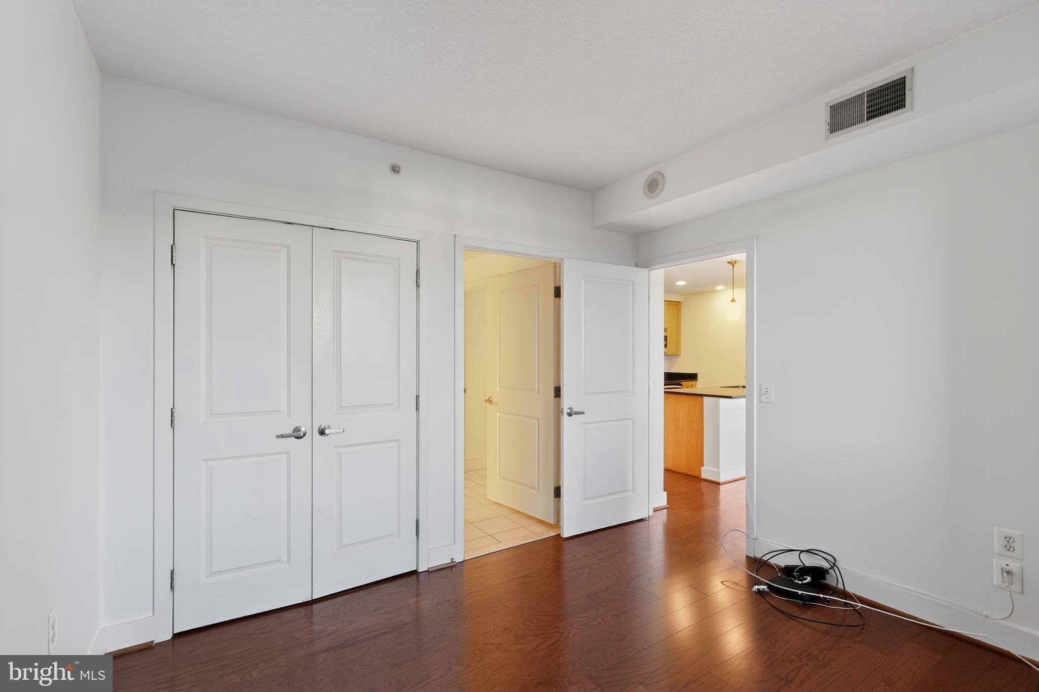 2001 15th Street North, Unit 420 Arlington, VA 22201 - Photo 13 of 27 a view of a room with wooden floor and a window