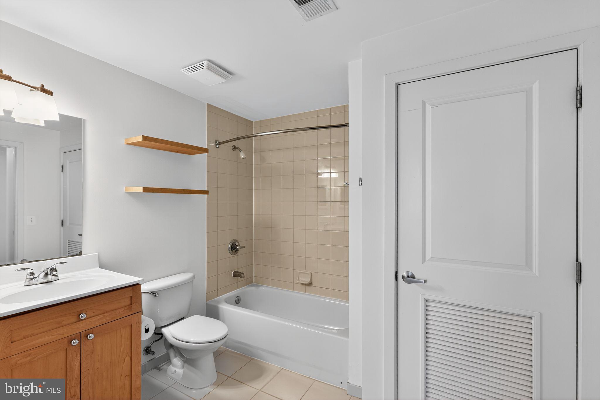 2001 15th Street North, Unit 420 Arlington, VA 22201 - Photo 14 of 27 a bathroom with a granite countertop sink toilet and shower