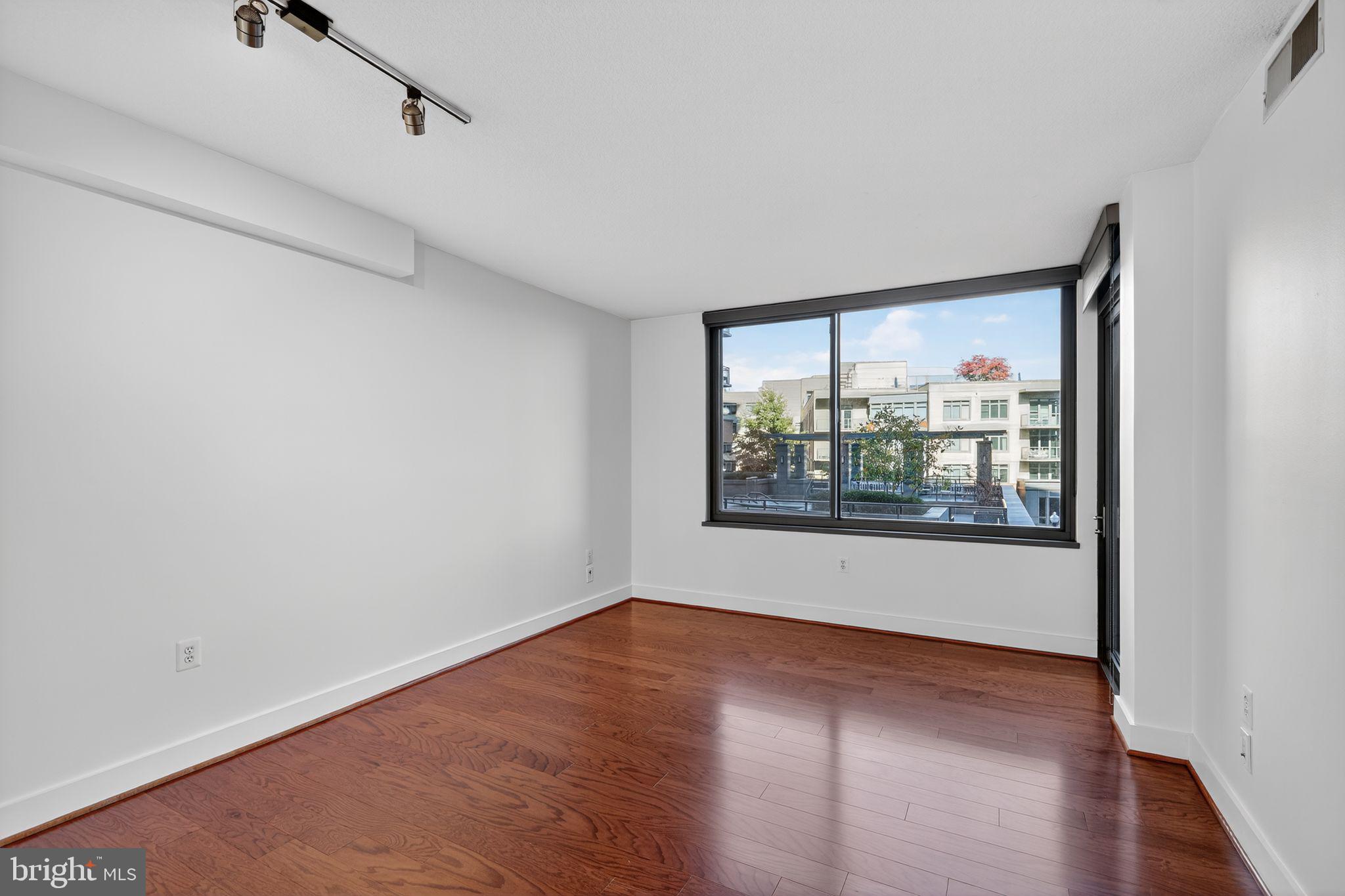 2001 15th Street North, Unit 420 Arlington, VA 22201 - Photo 9 of 27 a view of a big room with wooden floor and windows