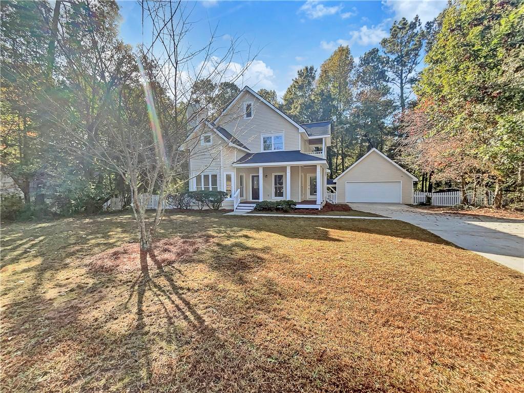 6580 Homestead Road Rex, GA 30273 - Photo 1 of 1 View of property with a garage, a front yard, and covered porch