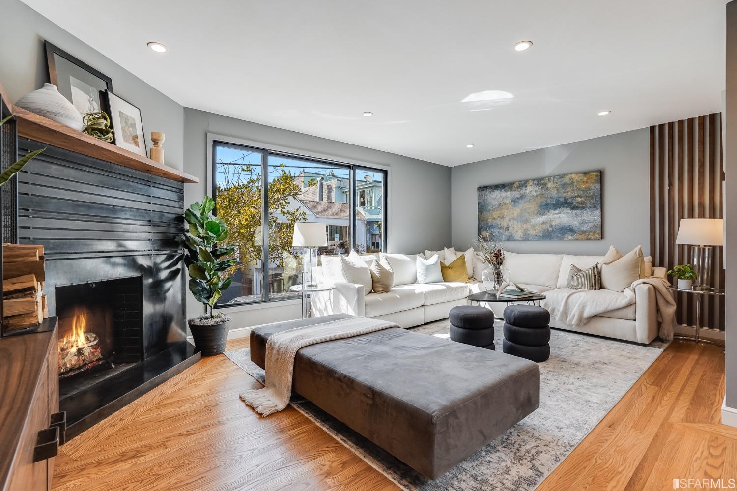 a living room with furniture large window and fireplace