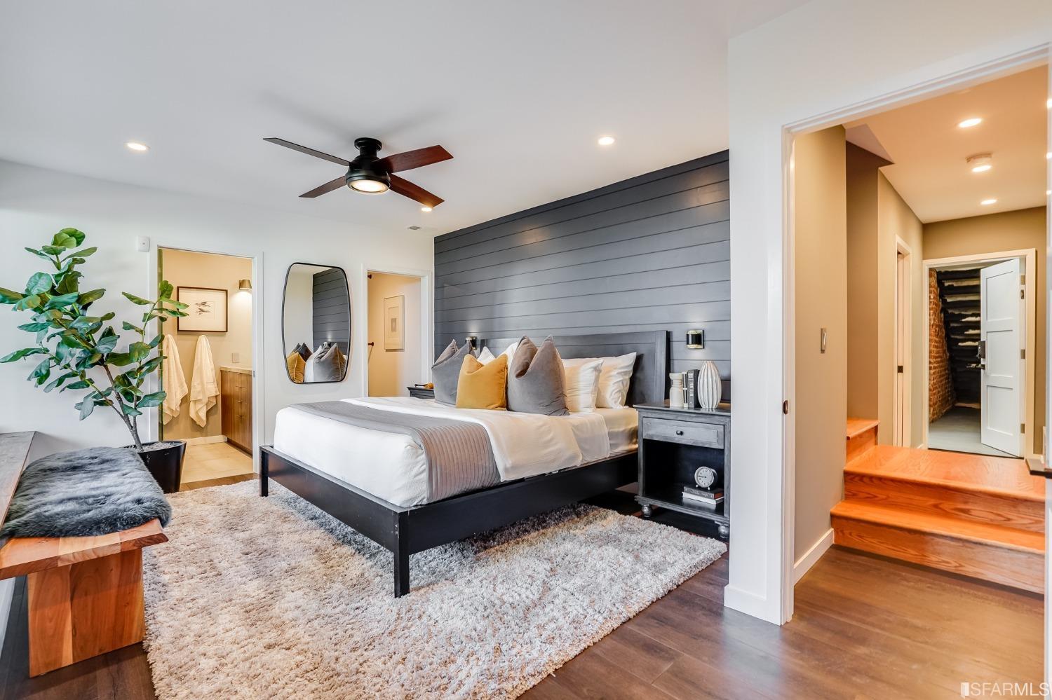 91 Bronte Street San Francisco, CA 94110 - Photo 14 of 24 a spacious bedroom with a bed and a potted plant